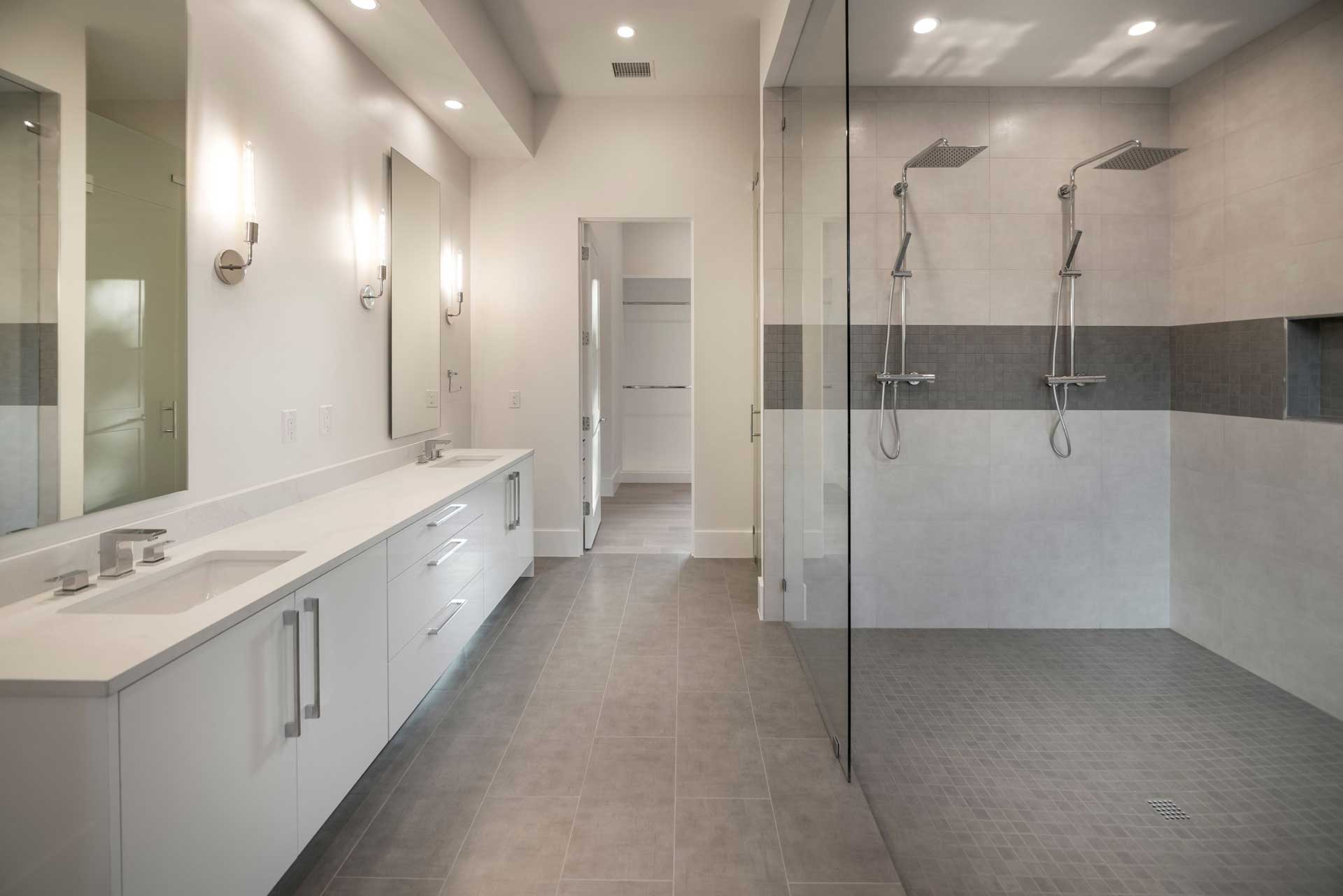 a bathroom with a glass shower and sink