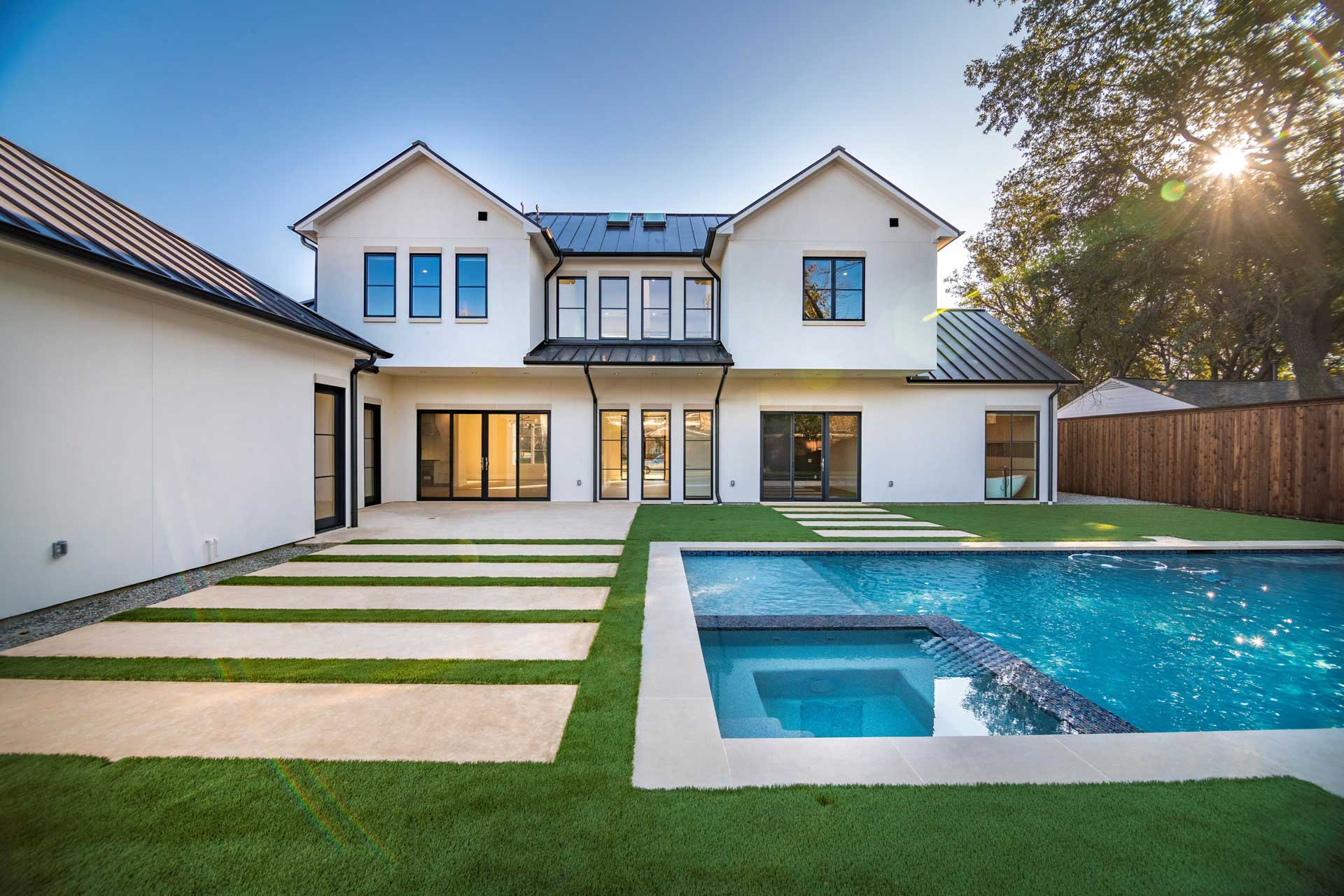 a house with a pool and grass
