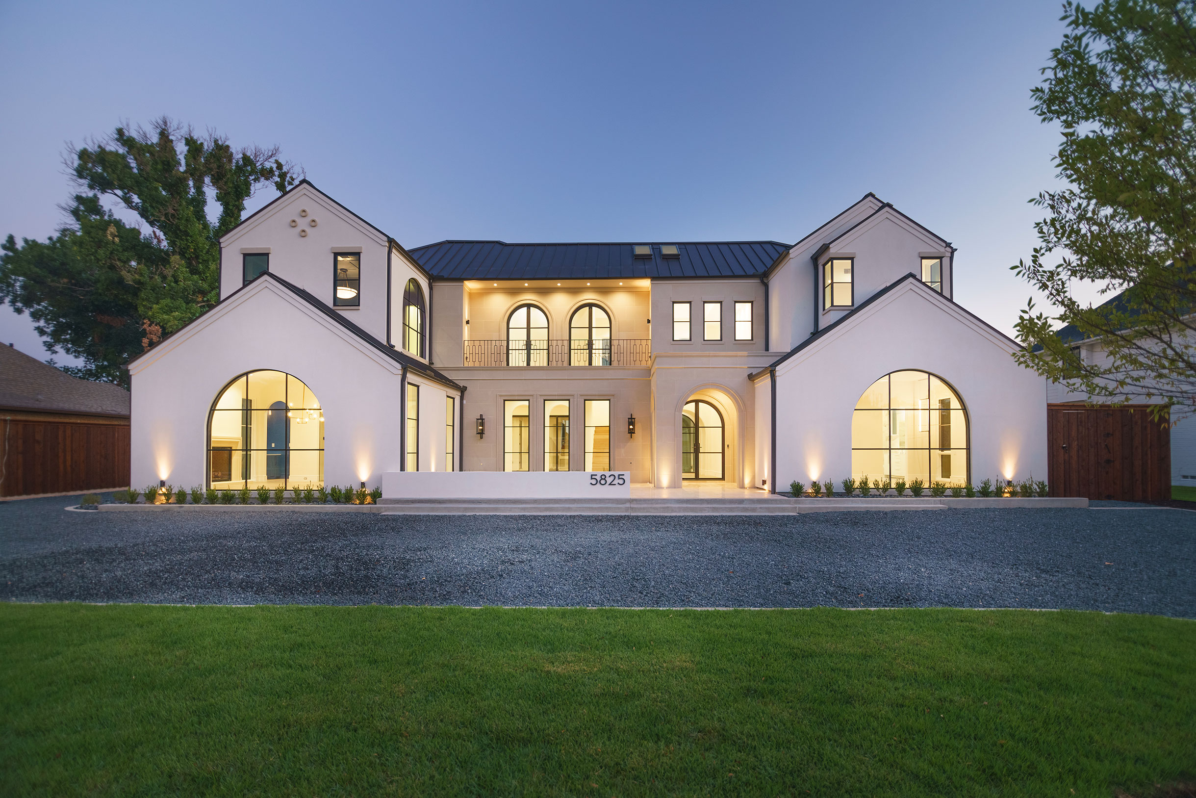a large white house with a lawn