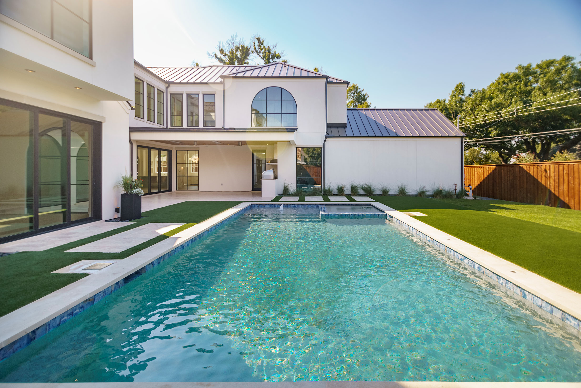 a white house with a stone wall and a stone wall with a stone wall and a stone wall with a stone