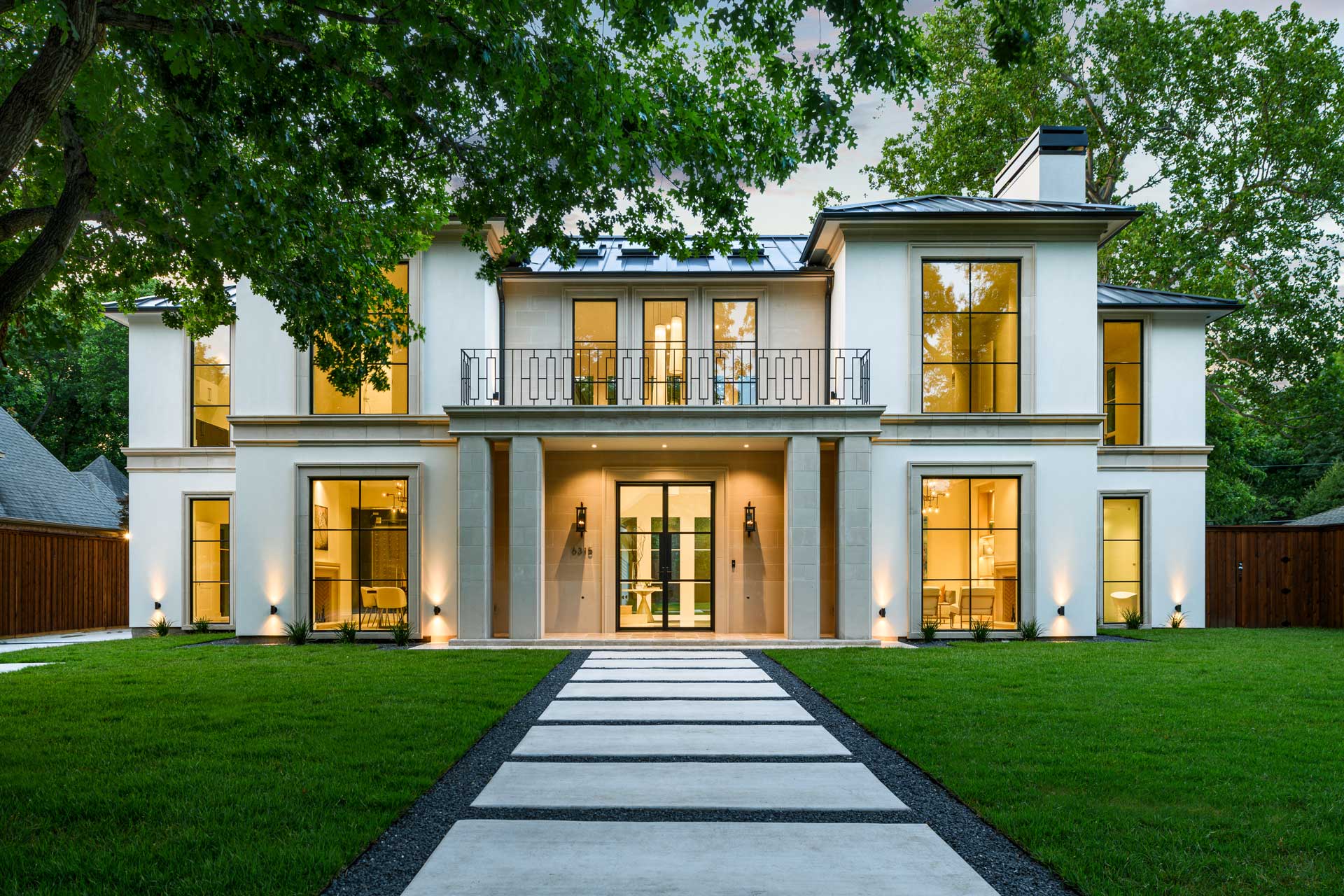 a large white house with a lawn