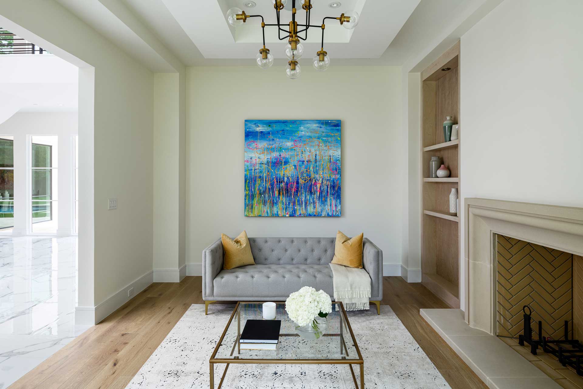 a living room with a couch and a painting