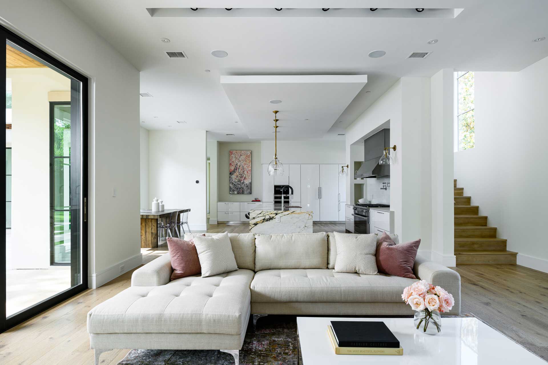 a living room with a large couch and a kitchen