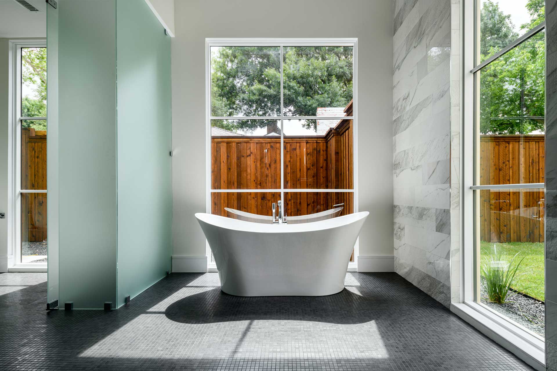 a bathroom with a tub and a window