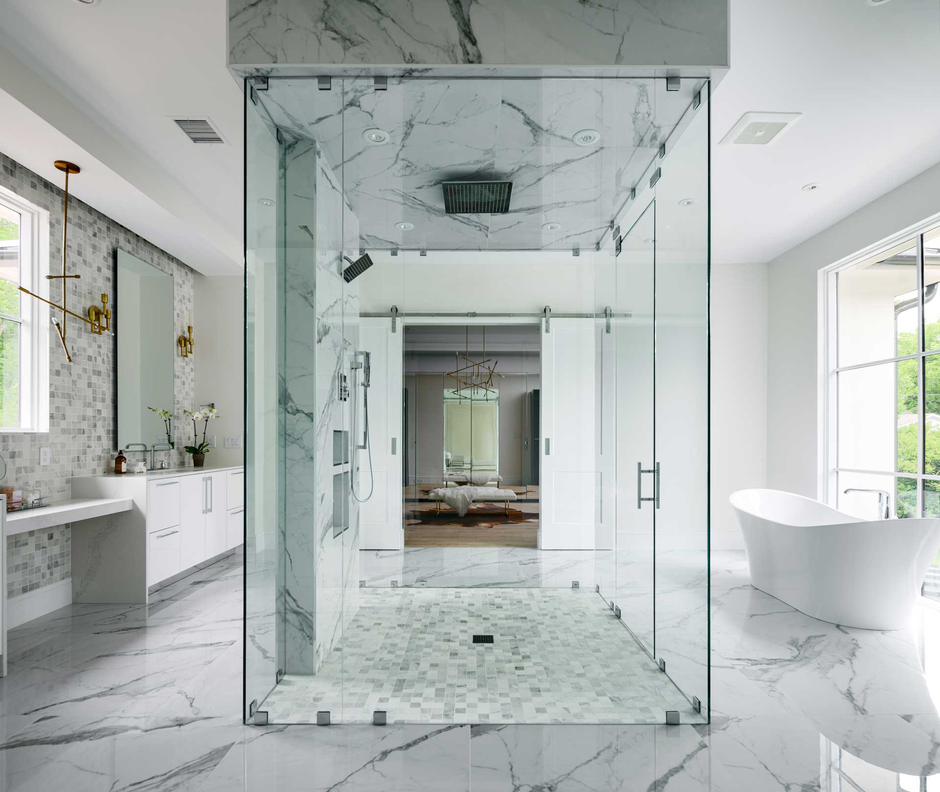 a bathroom with a glass shower and a tub