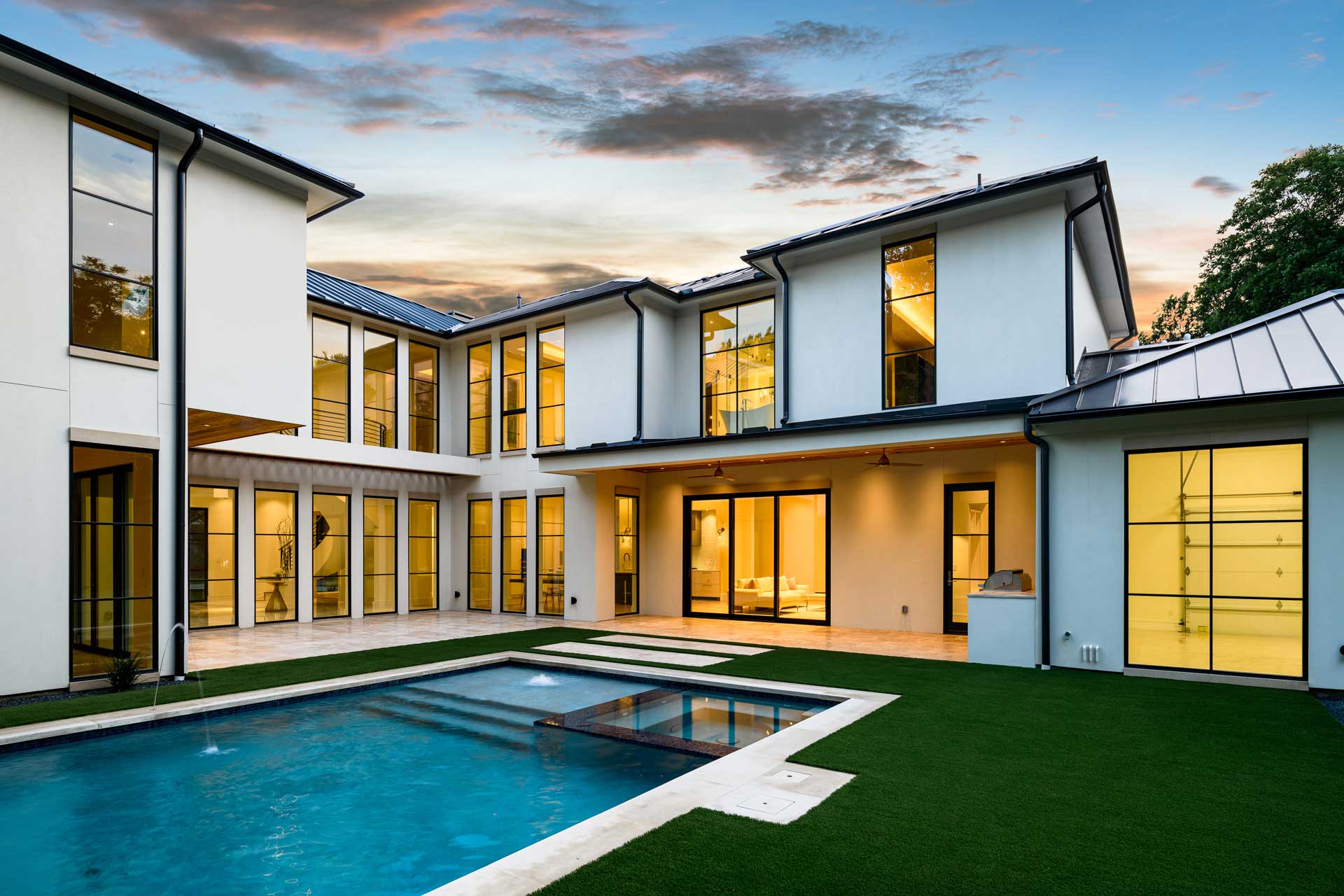 a white house with a stone wall and a stone wall with a stone wall and a stone wall with a stone