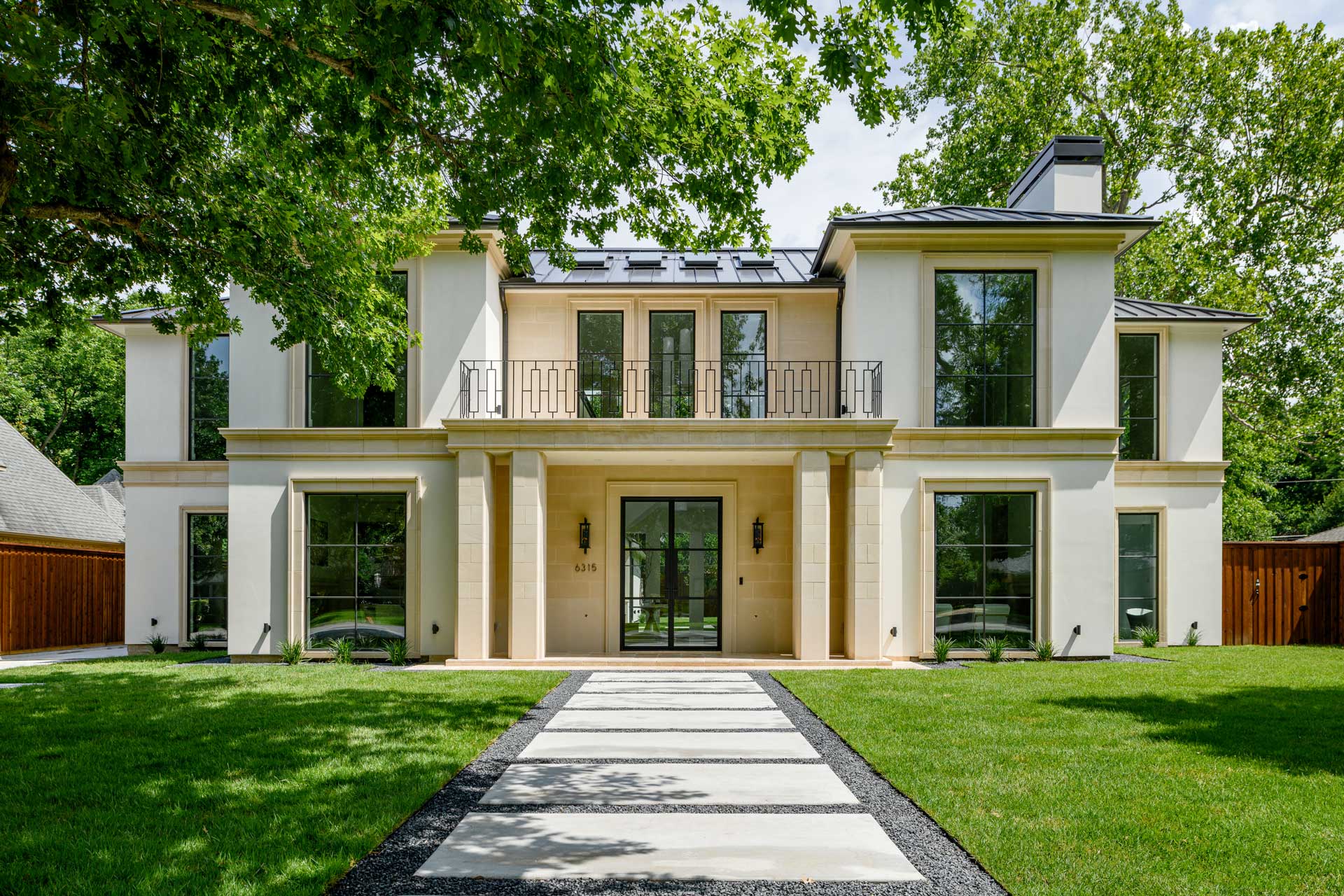 a large white house with a lawn