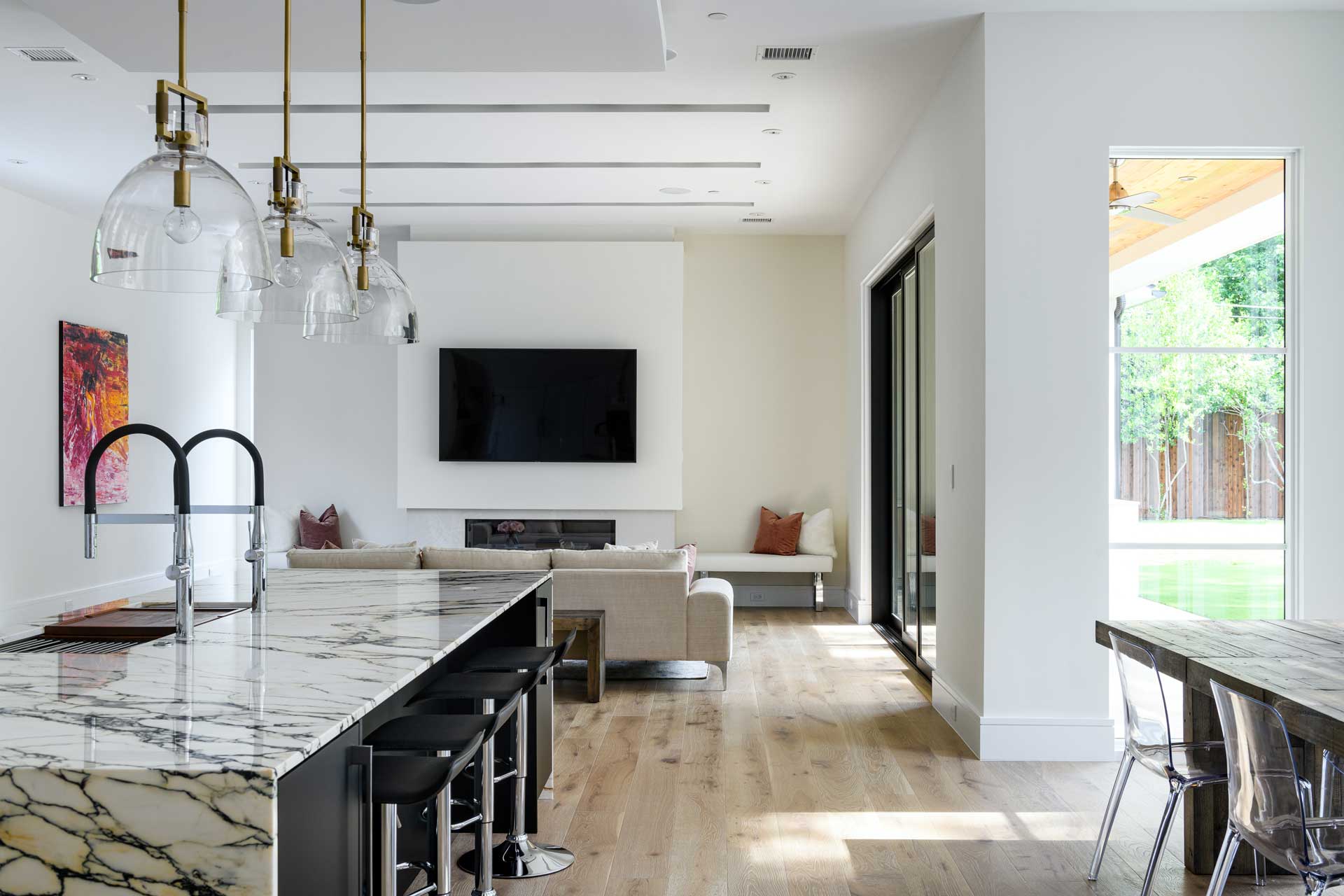 a living room with a large couch and a kitchen