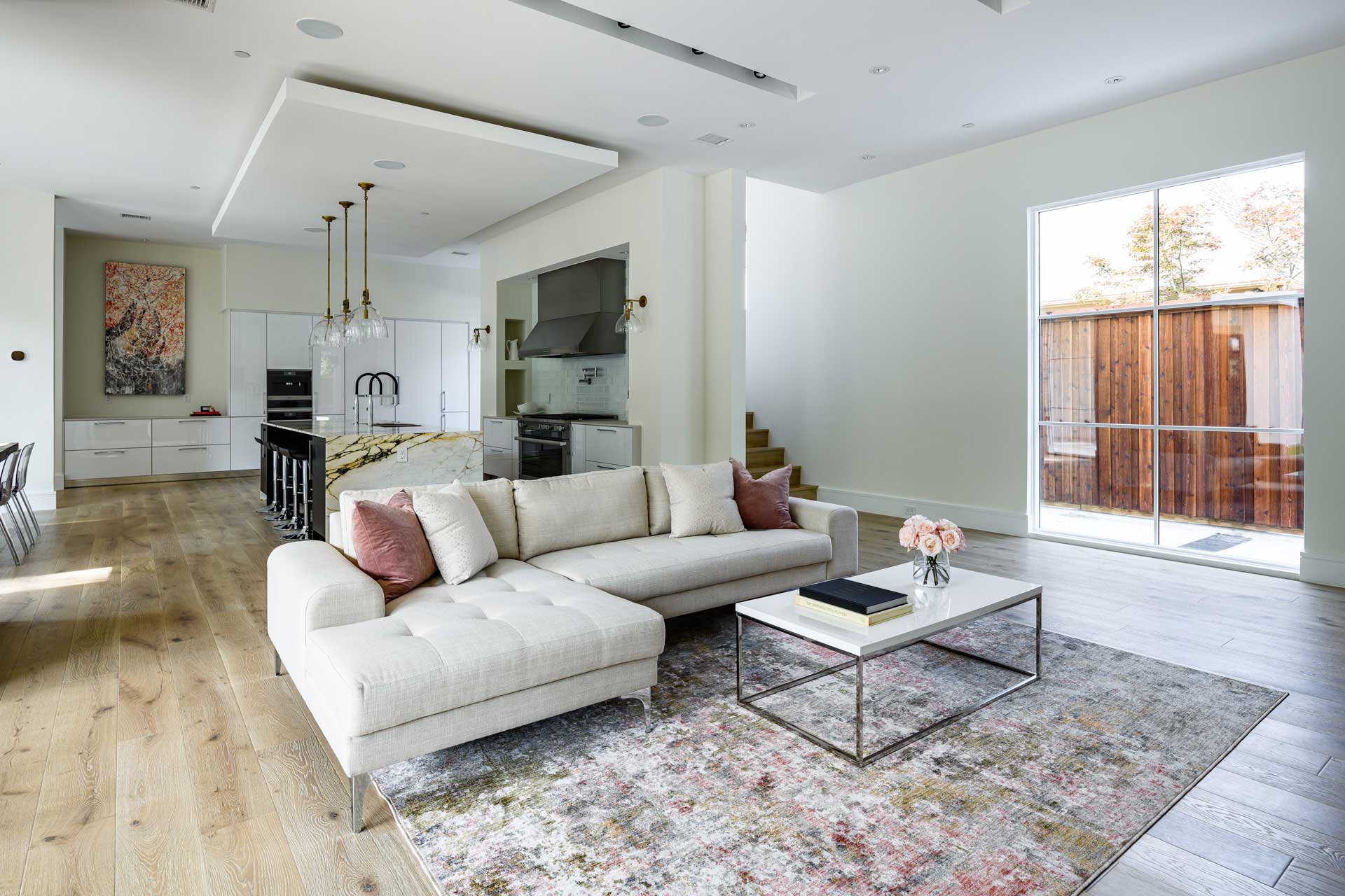 a living room with a large couch and a kitchen