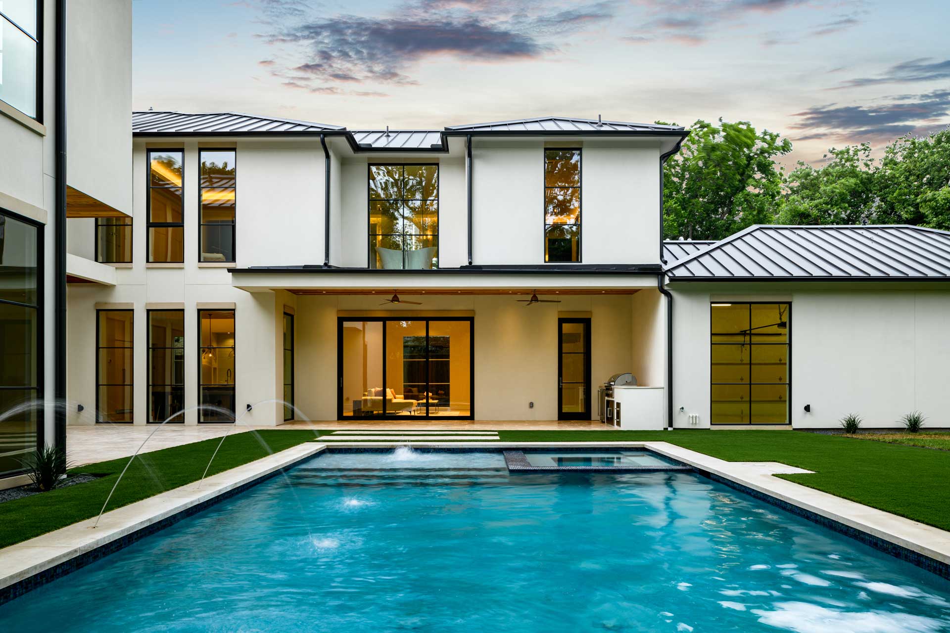 a white house with a stone wall and a stone wall with a stone wall and a stone wall with a stone