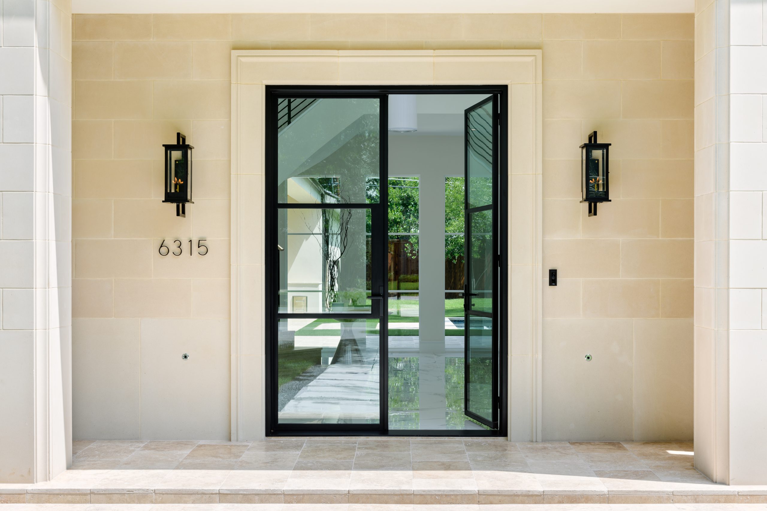 a glass door with a glass door and a stone wall