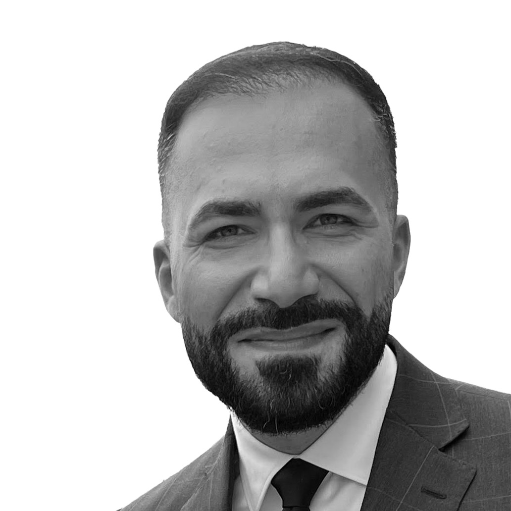 a person with a beard and mustache wearing a suit and tie