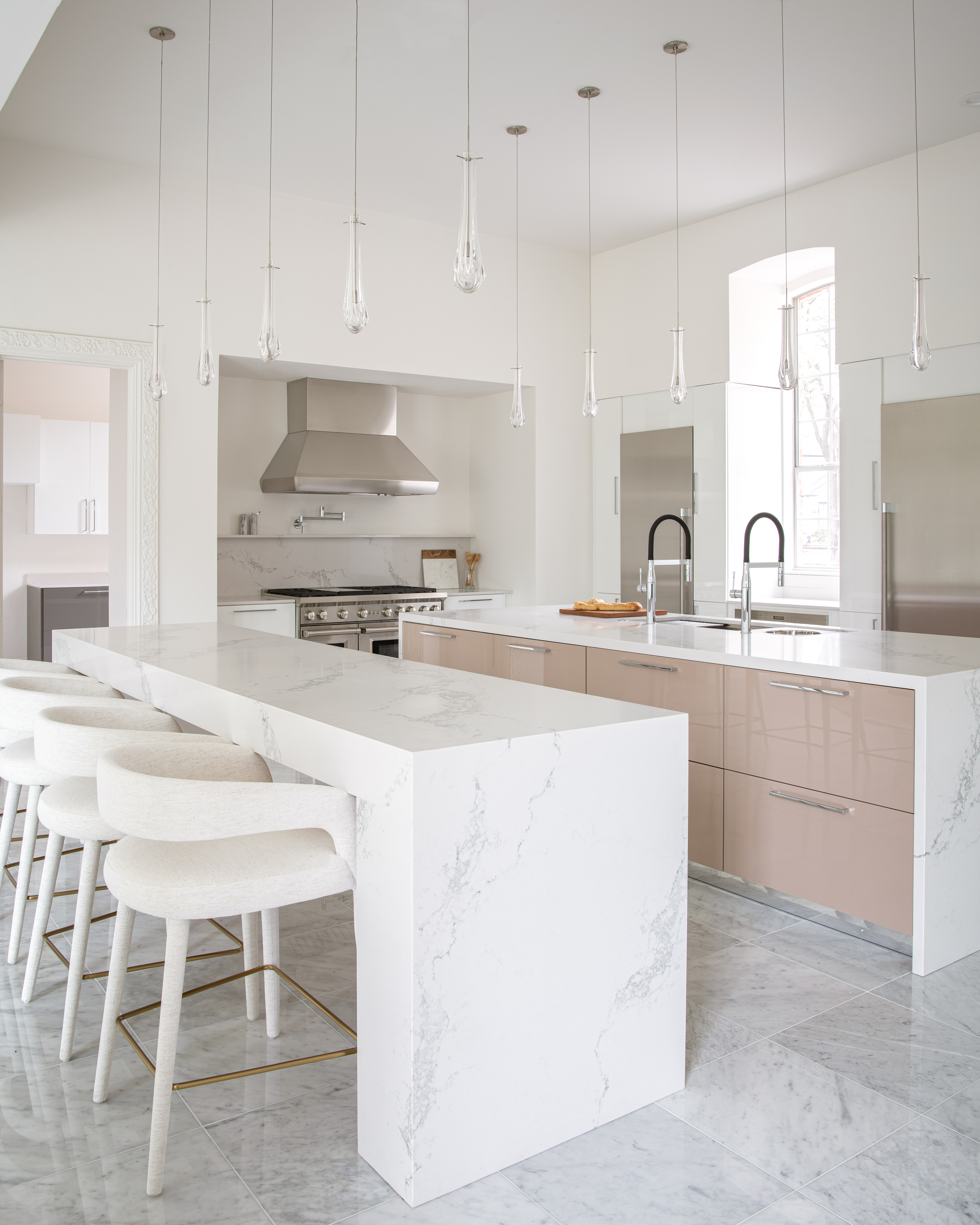 a kitchen with a bar and stools