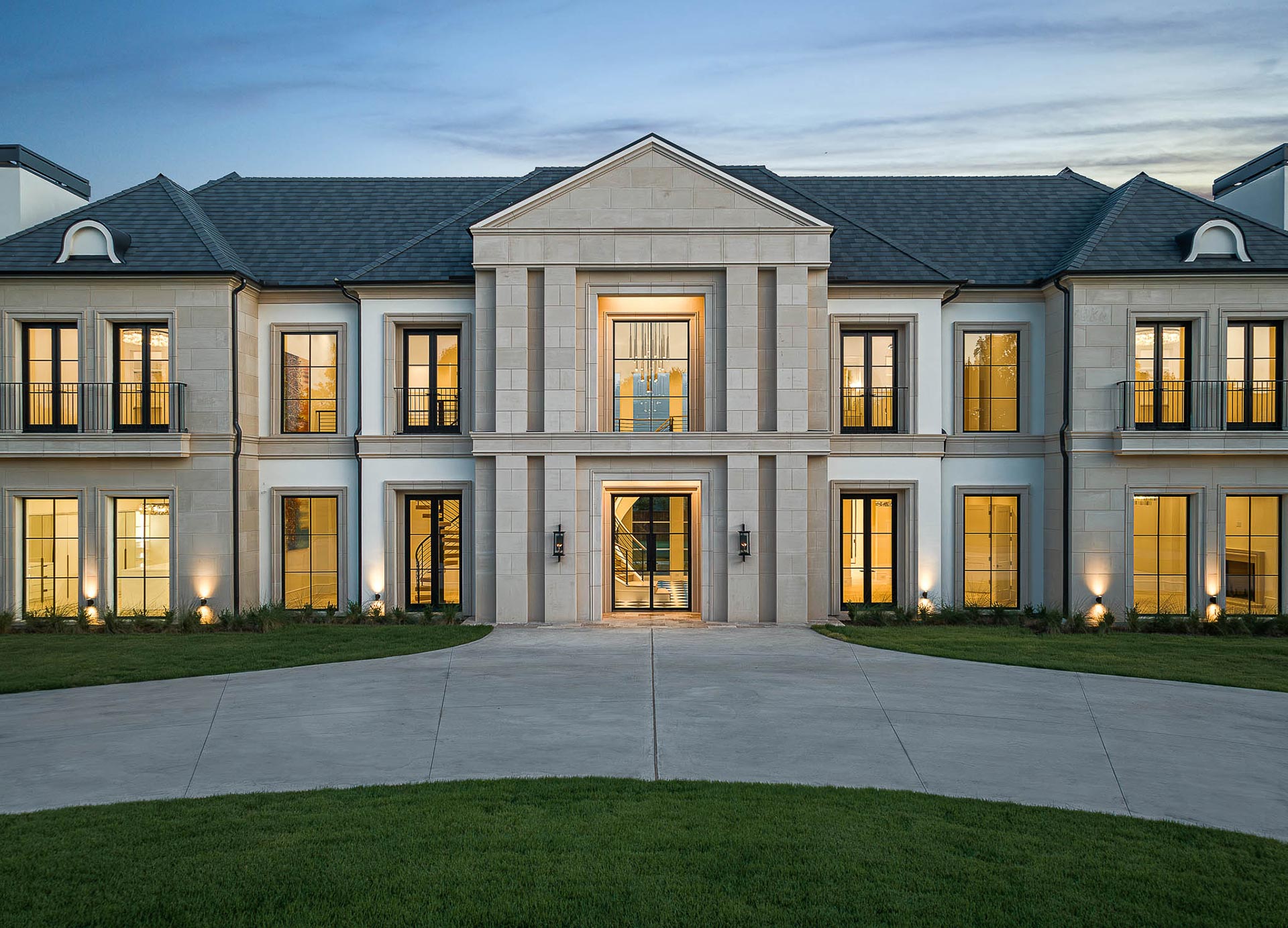 spacious, contemporary home featuring a wide driveway, showcasing modern architectural design and ample outdoor space.