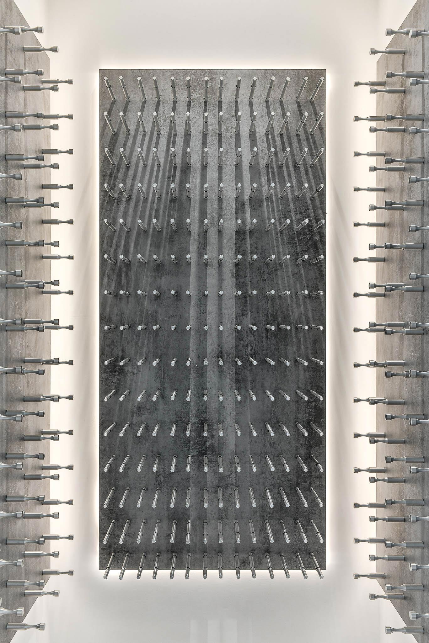 A spacious room featuring an extensive wall adorned with numerous wine bottles, showcasing a variety of labels and colors.